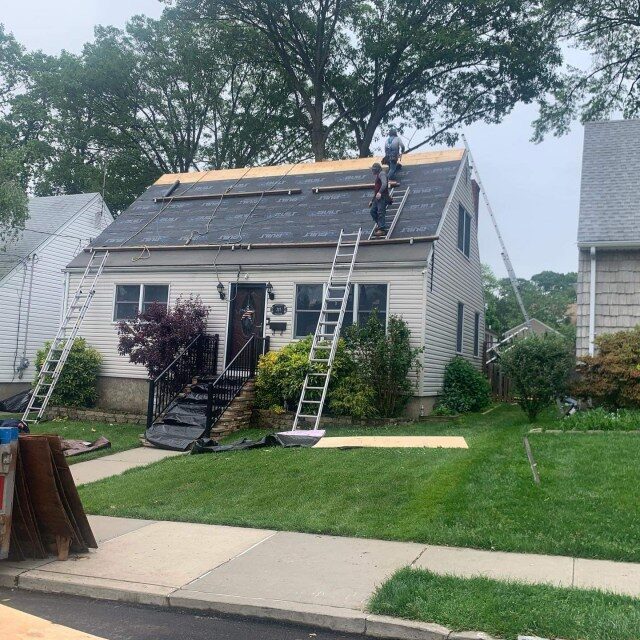 Cape style home two roofers TRI-BUILT underlayment mid install NJ