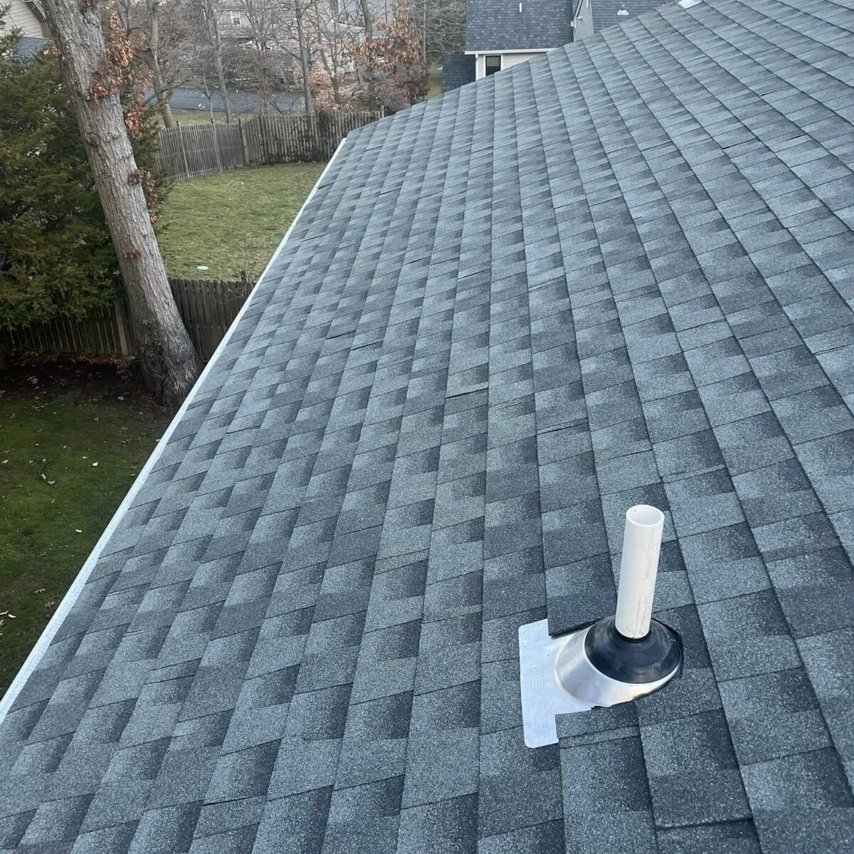 Gray shingle roof new plumbing vent rubber boot NJ