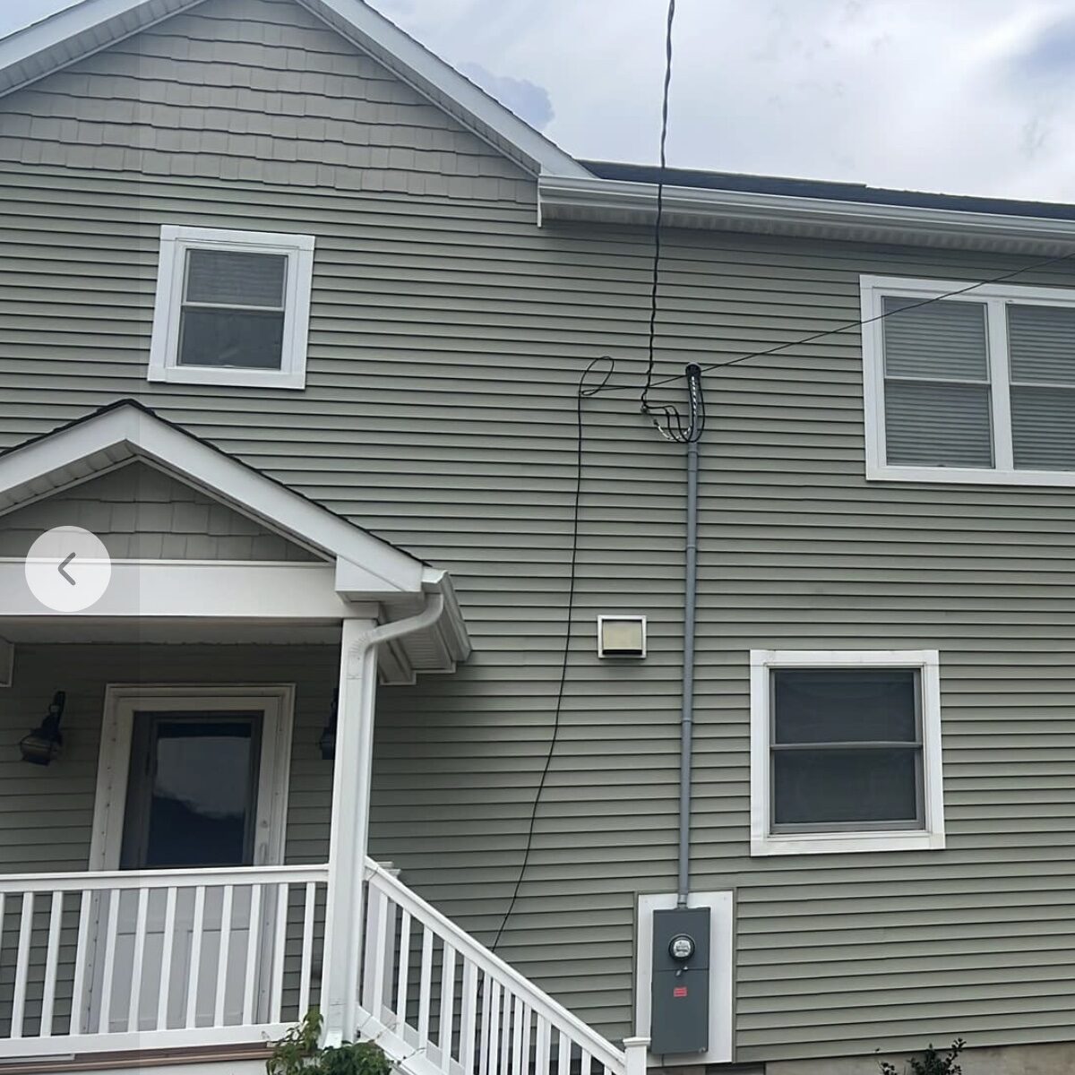 Rear elevation sage green home new dark roof NJ