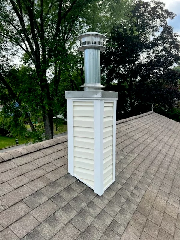 White vinyl chimney chase stainless flue cap gray shingle roof NJ