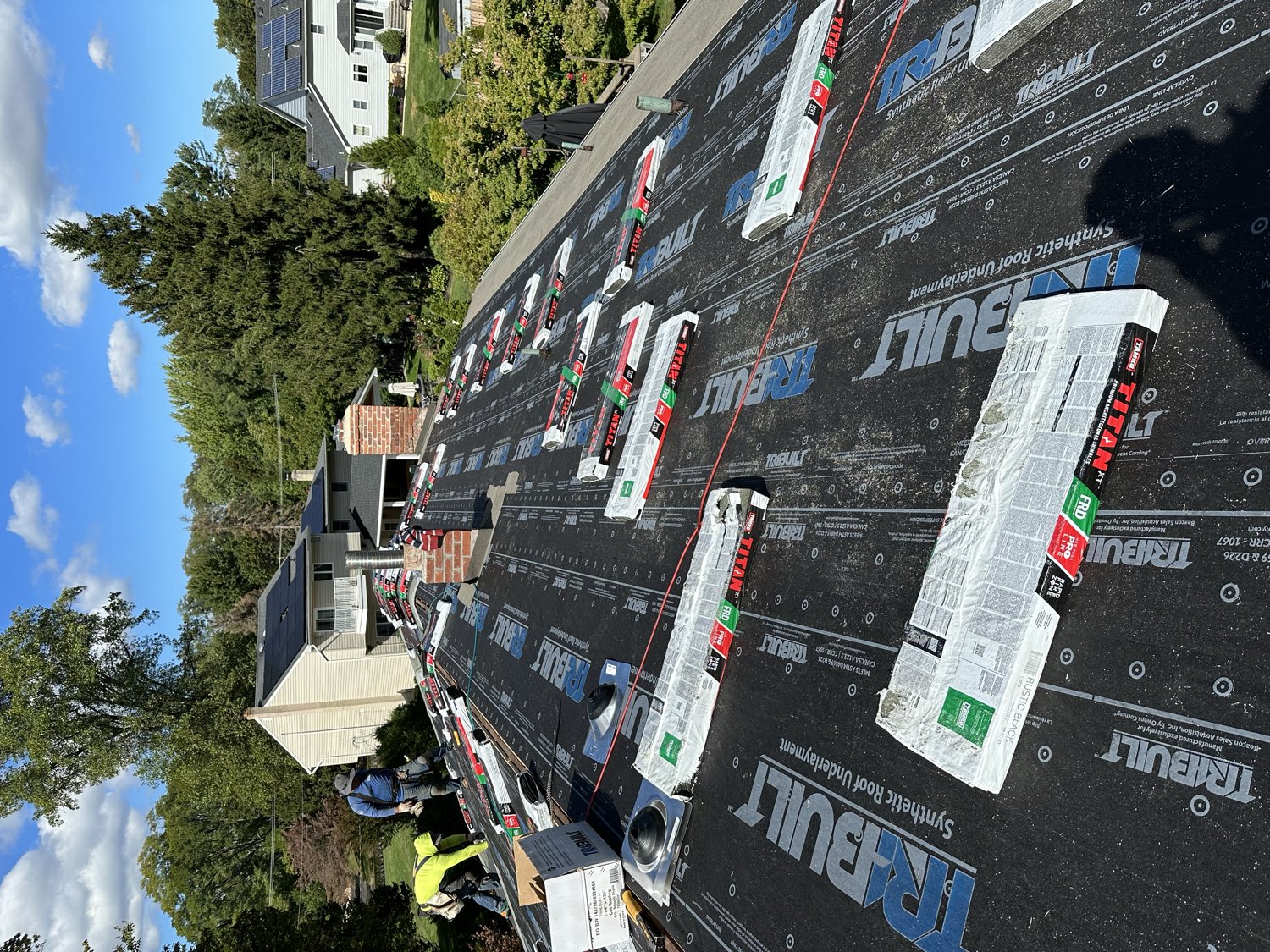 Synthetic underlayment installed shingle bundles staged roof deck NJ