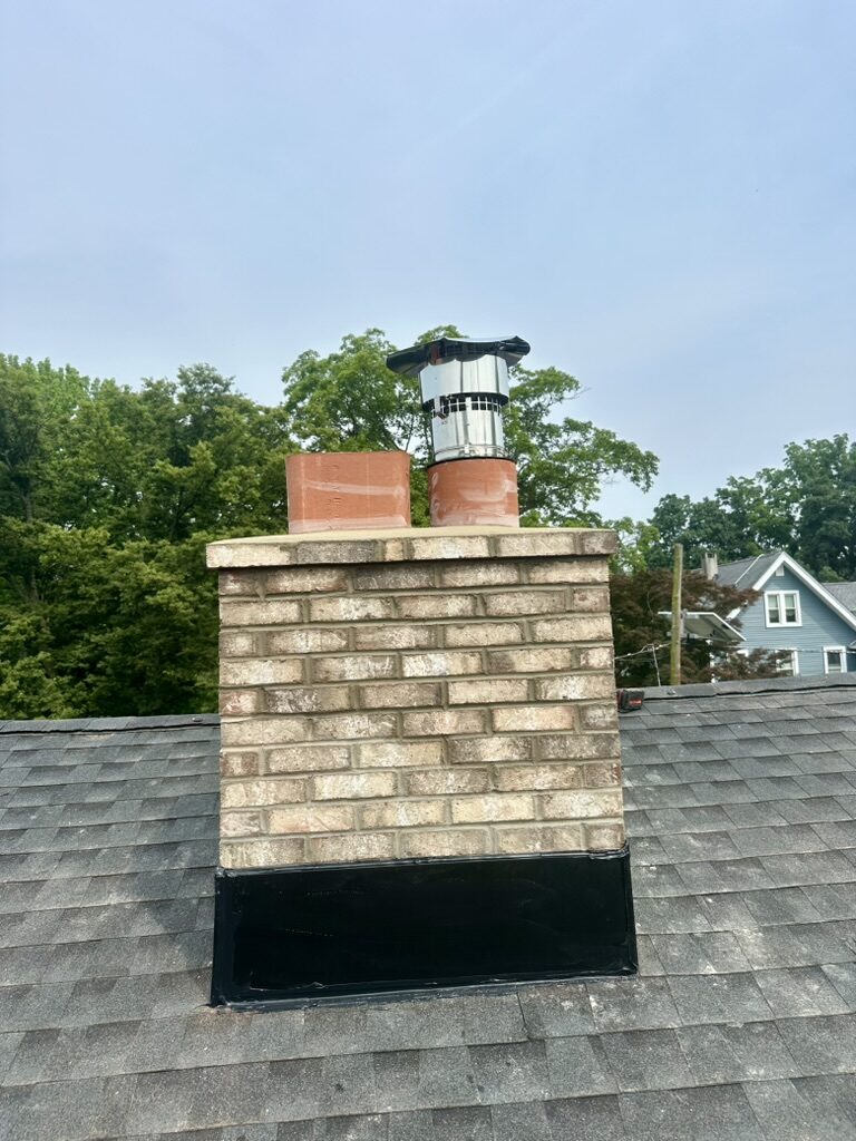 Chimney rebuild in progress back view new flue tiles NJ