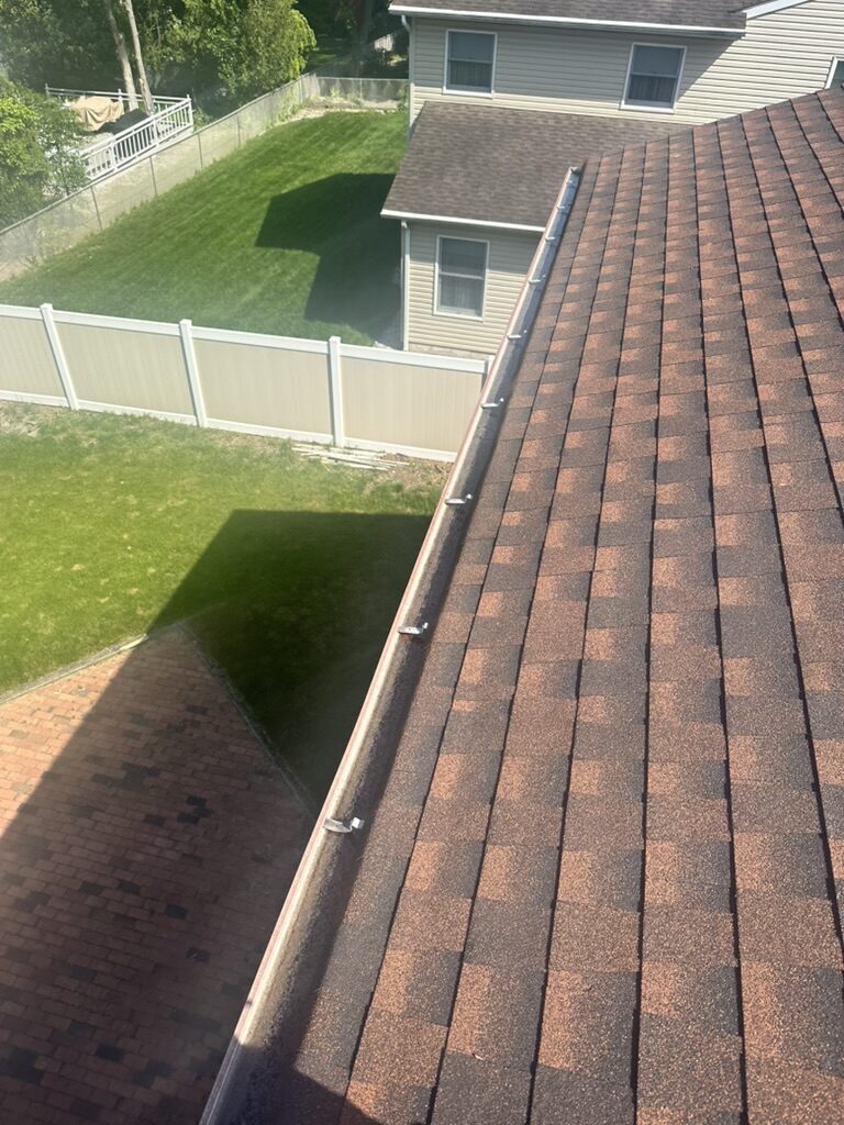 Aerial view completed brown shingle roof new gutter guards NJ