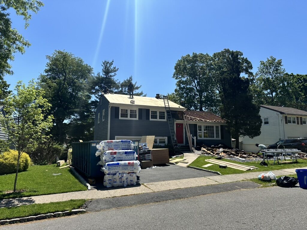 Full roof tear off crew on roof plywood exposed dumpster NJ