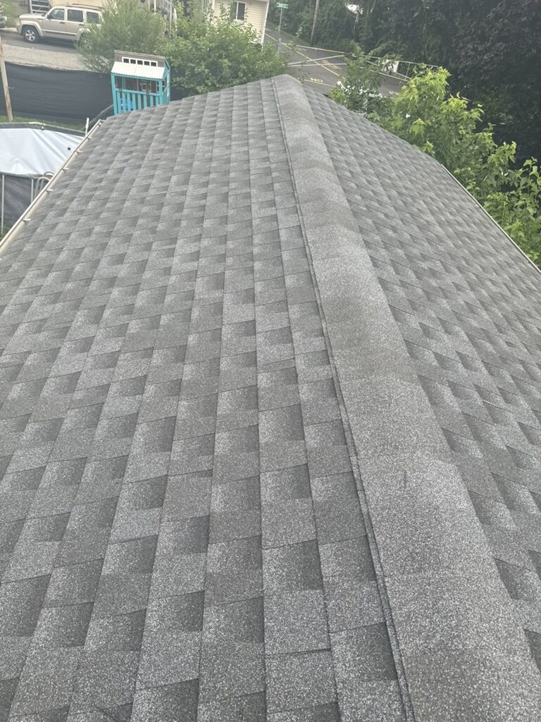 Gray architectural shingles ridge cap close up aerial NJ